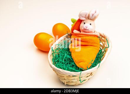 Easter bunny made of fabric in a sleeping bag in the Easter basket Stock Photo