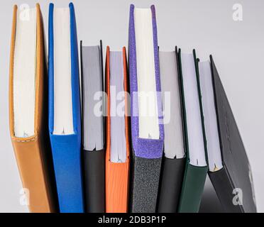 several books of different colors seen from zenital perspective on white background Stock Photo