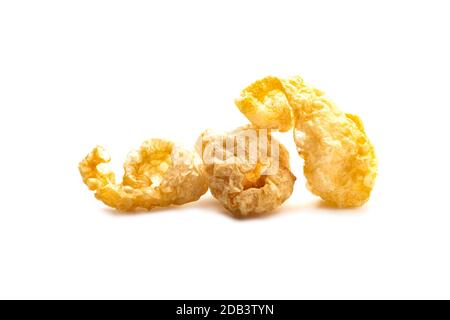 Pork snack crispy and blistered isolated on white background. Crispy pork skin pieces. Food concept. Stock Photo