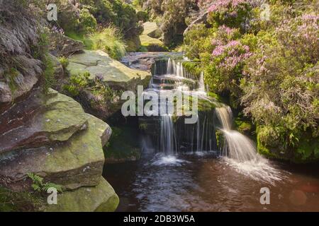 A small waterfall on the rocks in the Peak District near Middle Black Clough Stock Photo