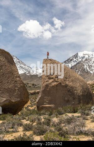 Rock climber on top of rock formation, Bishop, California, USA Stock Photo