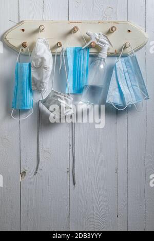 Various of masks and liquid disinfection against coronavirus Covid-19 on hanger Stock Photo