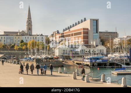 Walking the East Pier on a sunny day with a view of Dun Laoghaire seafront in County Dublin, Ireland Stock Photo