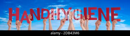 People Hands Holding Red German Word Handhygiene Means Hand Hygiene. Blue Sky As Background
