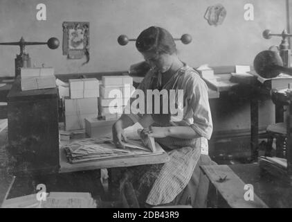 15-year old girl at her old job packing the finished envelopes. Embossing shop of Harry C. Taylor, 61 Court Street. Location: Boston, Massachusetts . Stock Photo
