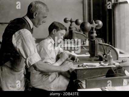 14-year old Fred cutting dies for a new job. Embossing shop of Harry C. Taylor. 61 Court Street. Location: Boston, Massachusetts. Stock Photo