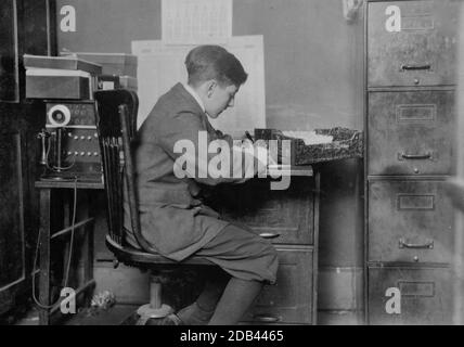 Young office boy, working for J.J. O'Brien and Sons on East 23 Street. Past 16 years. Location: New York, New York. Stock Photo