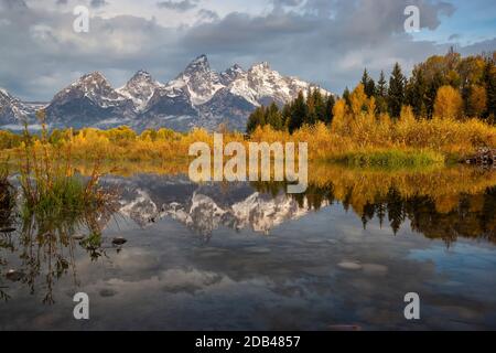 This picture was taken from upper Schwabacher's landing after sunrise during the fall of 2017. The Cathedral group ( Nez Perce Peak, Middle Teton, Gra Stock Photo