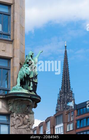 bronze statue pointing to the tower of the St. Nicholas church in Hamburg, Germany Stock Photo