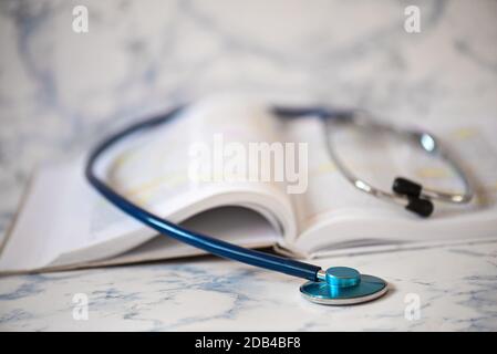 Stethoscope on the pages of a text book Stock Photo