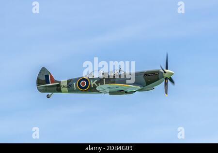 Supermarine Spitfire vintage World War 2 aircraft, SM520, previously scrapped but restored & converted to 2-seater plane, flying in a display. Stock Photo