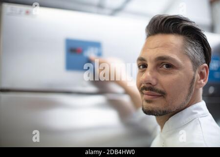 young factory technician psoing at workplace Stock Photo