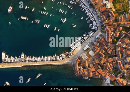 Top view of docks in Croatia with yachts and boats in summer at sunrise. Aerial footage of touristic destination in Mediterranean sea. Komiza on Vis i Stock Photo