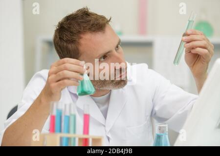 young male scientist doing experiments in laboratory Stock Photo