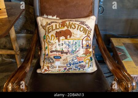 Wyoming, USA - September 25, 2020: Detaiiled, embroidered throw pillow sitting on a wooden chair, in Yellowstone National Park Stock Photo