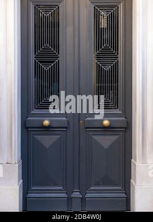 Wooden entrance door, white marble frame, luxury residential building entrance in old town of Plaka, Athens Greece Stock Photo