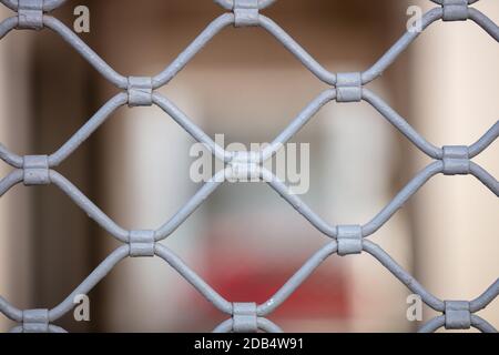 Metal roller shutter grilled texture background, gray color. Store entrance closed, security safety Stock Photo