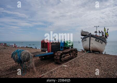 Hastings Port, East Sussex / UK -  2020.08.08: Bulldozers at Hastings fishing boats on the beach at Rock-a-Nore Stock Photo