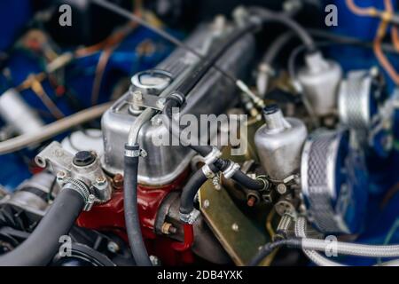 Close up with selective focus on vintage car engine block under open hood Stock Photo