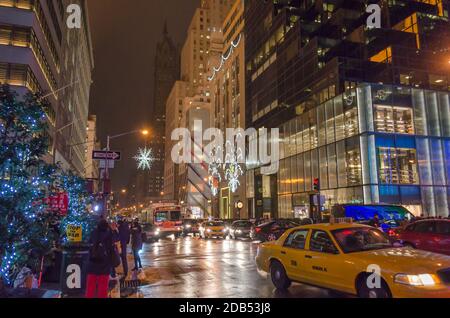 Busy Avenue Outside Trump Tower in Manhattan. Street Dressed in Christmas Mood with Bright Light Decoration and Illuminated Trees Across the Pavement Stock Photo