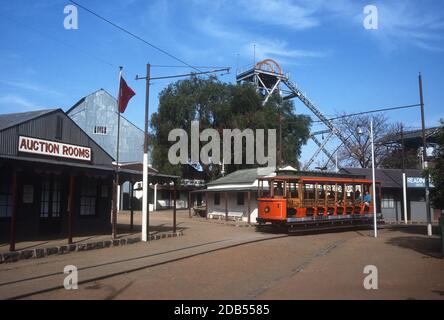 Tram and auction rooms building with winding gear in distance, Kimberley, South Africa Stock Photo