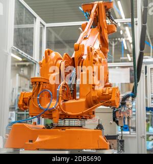 robot arms in the factory performs precise work according to the specified program. Stock Photo