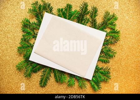 Blank white card and Christmas decor on golden background Stock Photo