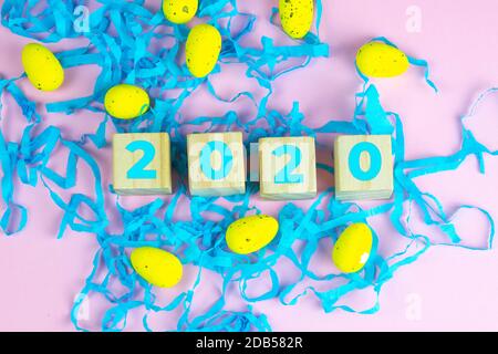 Word Easter on wooden cubes and surrounded with multiple egg decorations as a festive Easter background composition. Stock Photo