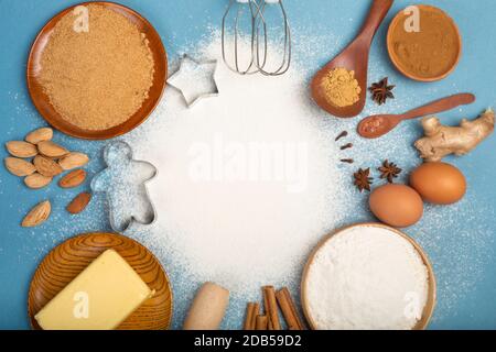 Christmas gingerbread cookies cooking background flat lay top view template with copy space for text. Baking utensils, spices and food ingredients on Stock Photo