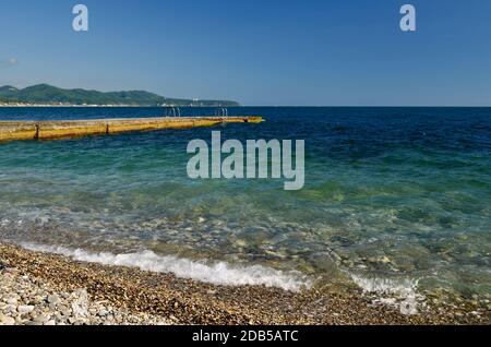 Seascape, view from the pebble shore on the rushing swirling wave. Stock Photo