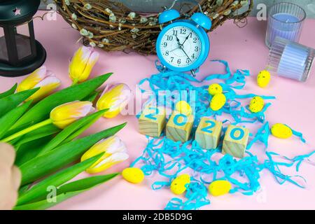 Word Easter on wooden cubes and surrounded with multiple egg decorations as a festive Easter background composition. Stock Photo