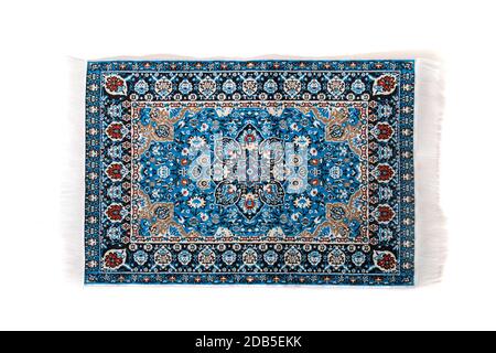 blue carpet with intricate design elements isolated on a white background. Stock Photo
