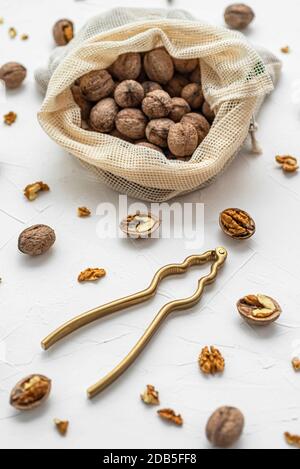 Walnut with nutcracker on white background Stock Photo