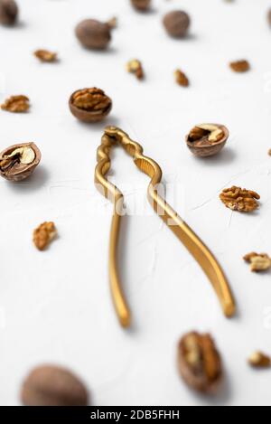 Walnut with nutcracker on white background Stock Photo