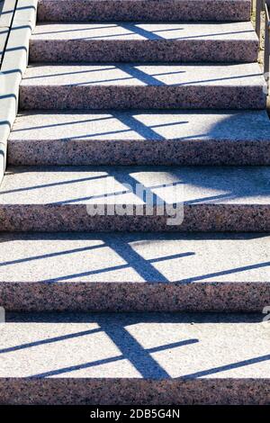 part and close-up of concrete stairs on the street, a real new design with shadows from the railing, Sunny day Stock Photo