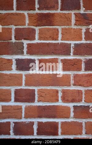 Portrait image of plain terracotta brick work suitable for use as wallpaper Stock Photo