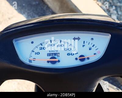 Black motorcycle speedometer with white scoreboard and red arrow. Closeup photo Stock Photo