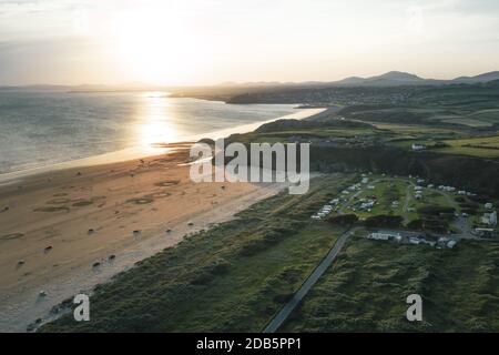 Aerial shoot over Black Rock Sands beach at sunset in North Wales, United Kingdom Stock Photo
