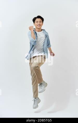 Young Asian man jumping in the air on white background. Stock Photo