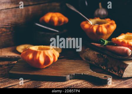 Preparing yellow pattypan squash for stuffing with minced meat Stock Photo