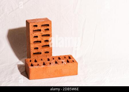 Red bricks podium for advertising product. Beige fabric background. Wabi sabi concept Stock Photo