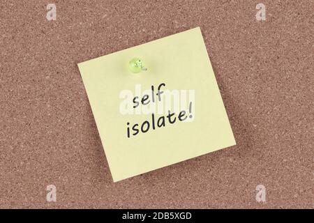 A self isolate post note on a cork notice board Stock Photo