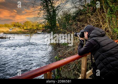 A teenage boy practising landscape photography at beautiful Beeliegh Falls. Beeliegh Lock is where the River Chelmer and River Blackwater merge. Stock Photo