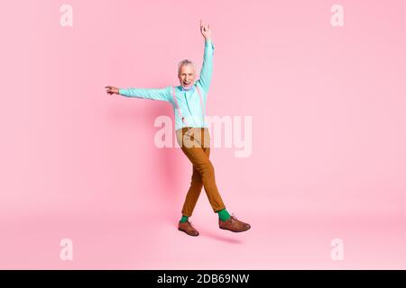 Full length body size photo of granddaddy fooling dancing pointing up smiling wearing bowtie isolated on pink color background Stock Photo