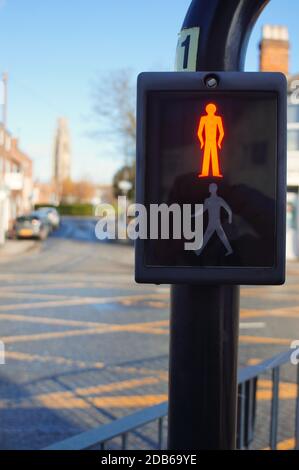 Close up of the wait sign of a pedestrian crossing with Boston Stump in soft focus background in Boston Lincolnshire. Stock Photo