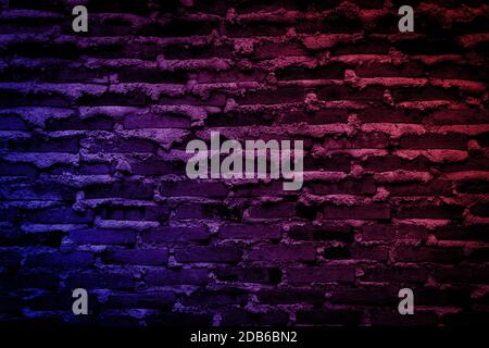 Neon light on brick walls that are not plastered background and texture. Lighting effect red and blue neon background vertical of empty brick basement Stock Photo