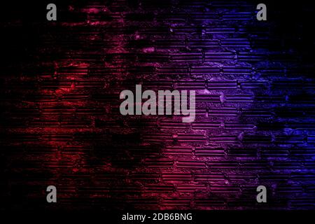 Neon light on brick walls that are not plastered background and texture. Lighting effect red and blue neon background vertical of empty brick basement Stock Photo