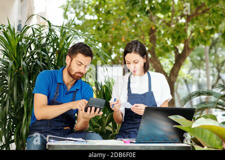Cafe owners checking bills Stock Photo