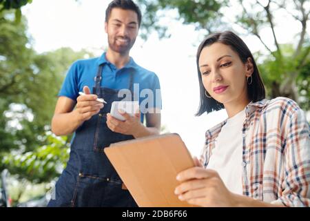 Pretty woman reading menu Stock Photo