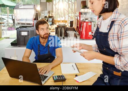 Cafe owners checking bills Stock Photo
